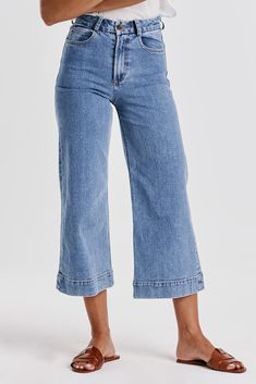 Super high rise cropped wide leg jeans. A statement-making denim wonder, resting at the natural waist and offering a relaxed silhouette in the hip and thigh. Cropped inseam on comfort stretch denim accented with back patch pockets, wide hem opening, back darts for lift support, matching button waistband closure, in a complementary medium shade.12 1/2" Front Rise (include waistband), 23" Leg Opening, 25" inseam (Size 27) COMFORT STRETCH: Slightly snug, give sometime to ease in, may go up one size 98% COTTON 2% SPANDEX Machine wash cold, Tumble dry low Imported Zip fly and button closure Patch pocket High Rise Bootcut Jeans, Cropped Wide Leg Jeans, Dear John, Slim Straight Jeans, Midi Maxi Dress, Cropped Denim, Swimwear Tops, Cropped Jeans, Wide Leg Jeans