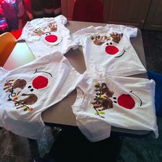 several white shirts with red polka dots on them sitting on a table in front of a television