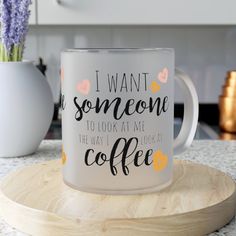 a white coffee mug sitting on top of a wooden coaster