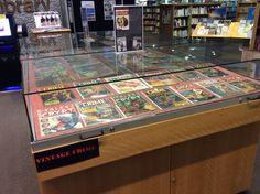 there are many books on display in the glass case