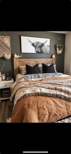 a bedroom with a bed, nightstands and pictures on the wall above it is shown