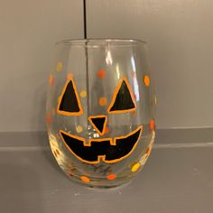 a wine glass decorated with orange and black polka dots