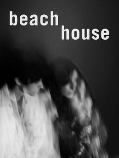 black and white photograph of three people standing in front of a wall with the words beach house on it