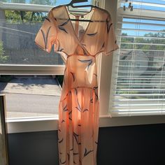 Peach Maxi Dress With Blue Leaves Side Cut Outs Criss Cross Top Zipper Down The Back Extremely Sheer & Not Linedwould Be Good For A Cover Up Size Small Pink Breezy V-neck Maxi Dress, Pink V-neck Breezy Maxi Dress, Peach Midi Maxi Dress For Day Out, Casual Peach Midi Dress With Short Sleeves, Peach Floral Print V-neck Midi Dress, Peach Short Sleeve Dress For Vacation, Peach Maxi Dress For Day Out, Short Sleeve Peach Vacation Dresses, Short Sleeve Peach Dress For Vacation