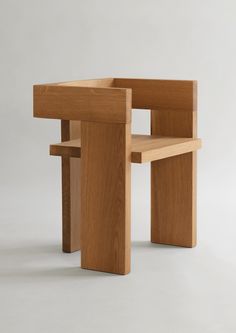 a wooden bench and chair sitting next to each other on a white surface with no one in it