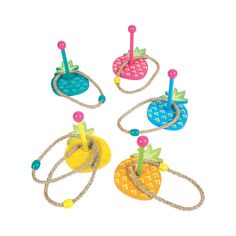 four colorful pineapples are tied to ropes on a white background and one is in the shape of an umbrella