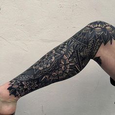 a person with a black and white tattoo on their arm