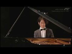 a man in a tuxedo sitting at a piano