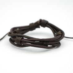 This twisted waxed leather cord bracelet is adjustable to fit most wrists. Available in brown or black. Size: 15mm wide. Adjustable Leather Strap Jewelry With Waxed Cord, Adjustable Waxed Leather Bracelet, Adjustable Waxed Finish Bracelets For Everyday, Adjustable Rugged Leather Bracelet, Adjustable Braided Leather Jewelry, Brown Braided Bracelet With Sliding Knot, Brown Waxed Cord Braided Bracelets With Adjustable Cord, Casual Leather Bracelet With Adjustable Cord, Brown Adjustable Braided Waxed Cord Bracelets