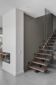 the stairs are made of metal and wood in this modern style living room with concrete flooring