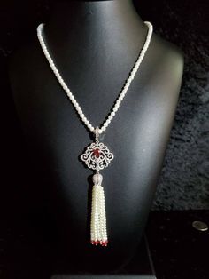 Stunning 4mm pearlized mother-of-pearl strung beads with removable clear and red crystal micro-pave enhancer and tassel. Elegant Red Beaded Pearl Necklace, Elegant Red Pearl Necklace, Elegant Red Necklace With Pearl Charm, Red Elegant Pearl Drop Necklace, Elegant Necklace With 108 Beads Pendant, Elegant Red Pearl Drop Necklace, Ocean Jasper Necklace, Red Crystal Necklace, Tiger Necklace