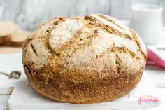 a loaf of bread sitting on top of a cutting board