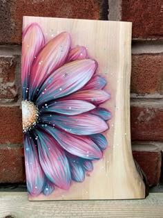 a painted wooden block with a flower on it