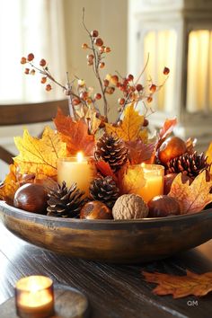 Cozy fall decor with candles, pinecones, and autumn leaves in a wooden bowl centerpiece. Perfect for high-end fall dining table decor ideas. Autumn Round Table Decor, Fall Table Display Ideas, Autumnal Table Decor, Luxurious Fall Decor, Fall Flower Arrangements For Home, Fall Office Decor Work, Autumn Table Centerpieces, Fall Indoor Decor Ideas, Autumn Decorations Diy