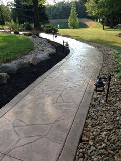 a stone path in the middle of a park