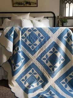 a blue and white quilt on a bed