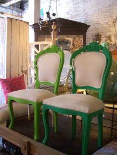 two green and white chairs sitting next to each other