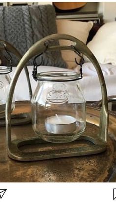 two glass jars sitting on top of a metal tray