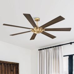 a ceiling fan in a bedroom with white walls and wood trimmings on the ceiling