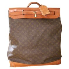 Beautiful and famous Louis Vuitton monogram canvas and cowhide leather steamer bag. It is one of the most iconic bag design from Louis Vuitton. Leather has got a very nice and rich caramel color patina. It comes with its Louis Vuitton leather name tag, its padlock and key. Its brown canvas interior is in very good condition too, no stain, no smell. Louis Vuitton is embossed inside its flap. As this bag is not sold any longer in Louis Vuitton stores, it is a genuine collector's piece now. Louis Vuitton Travel Bags, Designer Luggage, Louis Vuitton Travel, Iconic Bags, Garment Bag, Caramel Color, Bag Design, Brown Canvas, Garment Bags