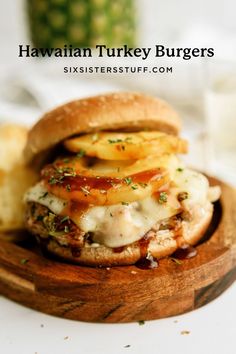 a close up of a burger on a wooden plate