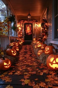 pumpkins are lit up on the front porch for halloween