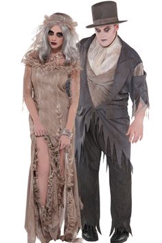 two people dressed in costumes standing next to each other