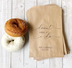 two donuts sitting next to each other on top of a piece of paper