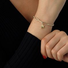 "This 14k Gold Bracelet is excellent for daily wear to have an elegant look. It may be adjusted to your size using the rolo rings itself. It also has double chain which is quite popular nowadays. With this bracelet, you will carry one of the stars you count every night. ◖ P R O P E R T I E S ◗ * Material: 14k Yellow Gold, 14k White Gold * Weight: 2.8gram (for 7\", without charm) * Weight: 3.5gram (for 7\", with charm) ◖ D I O N J E W E L ◗ ‣ 14K REAL GOLD ‣ EXPRESS DELIVERY IN 1-3 DAYS* ‣ HANDMA Metal Star-shaped Bracelets, Gold Chain Bracelet With Star Charm, Gold Star Charm Chain Bracelet, Dainty Star Charm Bracelet, Star Jewelry With Lobster Clasp, Gold Star Chain Bracelet As Gift, Gift Chain Bracelet With Star Charm, Metal Chain Bracelet With Star Charm As Gift, Paperclip Bracelet