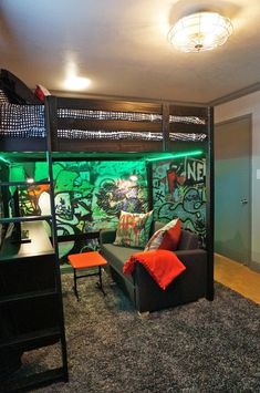 a living room with a couch and bunk bed next to a wall covered in graffiti