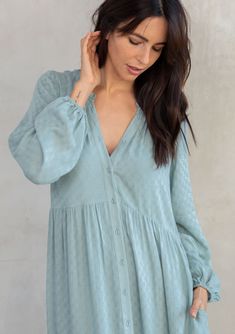 A classic bohemian maxi dress in a billowy silhouette, designed in textured checkered jacquard. This dreamy and versatile style features long voluminous sleeves, a delicate self-covered button front, and a ruffle-trimmed neckline. The tiered skirt adds shape and movement. Try this timeless style unbuttoned over denim! Checkered jacquard Relaxed, flowy fit Long voluminous sleeves Elastic wrist cuffs Maxi length Ruffle-trimmed tiered skirt Ruffle-trimmed round neckline Self-covered button front Si Spring Maxi Dress With Ruffles And Lantern Sleeves, Billowy Long Sleeve Maxi Dress With Ruffles, Flowy Puff Sleeve Maxi Dress For Daywear, Flowy Maxi Dress With Puff Sleeves For Daywear, Chic Crinkle Texture Dress For Daywear, Chic Crinkle Texture Maxi Dress For Spring, Chic Spring Maxi Dress With Crinkle Texture, Billowy Long Sleeve Maxi Dress For Daywear, Fall Maxi Dress With Balloon Sleeves