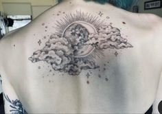 the back of a woman's upper half with clouds and sun tattoo on it