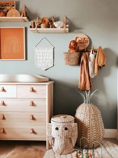 a baby's room with two baskets on the wall and other items hanging from the shelves