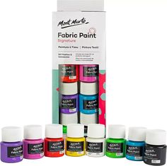 an assortment of different colors of fabric paint in front of a cardboard box with the package