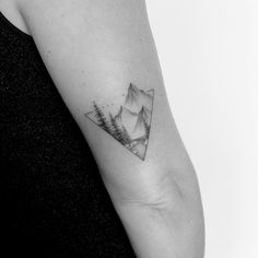 a mountain landscape tattoo on the arm