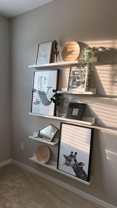 three shelves with pictures and other items on them