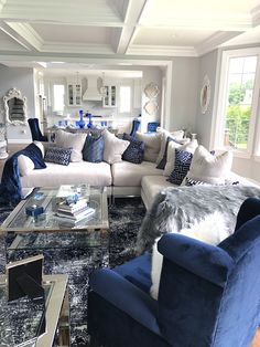 a living room filled with blue and white furniture