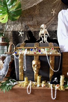 there is a trunk with beads on it and a skeleton figurine next to it