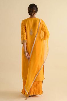 Yellow chanderi kurta with gota patti embroidery in floral pattern. Paired with crushed mulmul palazzo and organza dupatta.
Components: 3
Pattern: Embroidery
Type Of Work: Gota patti, floral
Neckline: Round
Sleeve Type: Three quarter
Fabric: Kurta: Chanderi, Palazzo: Mulmul, Dupatta: Organza
Color: Yellow
Other Details: 
Lace border embroidered sheer dupatta
Gota cutwork border
Occasion: Puja - Aza Fashions Gota Patti Embroidery, Kurta Palazzo Set, Yellow Kurta, Palazzo Set, Organza Dupatta, Women Kurta, Pattern Embroidery, Straight Kurta, Lace Border