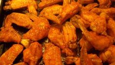 chicken wings are being cooked in an oven