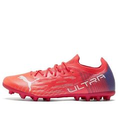 a red soccer shoe with the word puma written on it