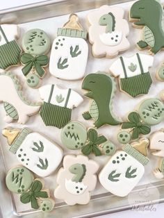 decorated cookies in the shape of baby's first christmas gifts are displayed on a tray