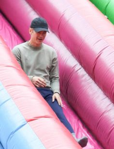 a man sitting on top of an inflatable slide