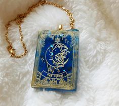 a blue and gold necklace with an image of a man's face on it