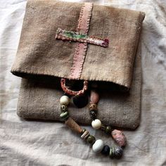 a cross is on top of a book with beads