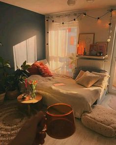 a bed room with a neatly made bed and lots of pillows on top of it