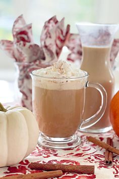 two mugs filled with hot chocolate and cinnamon