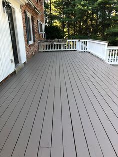 a large wooden deck with white railings