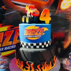 a birthday cake made to look like a monster truck with flames on the sides and numbers