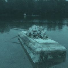 an old bus is sitting in the water with snow on it's hoods